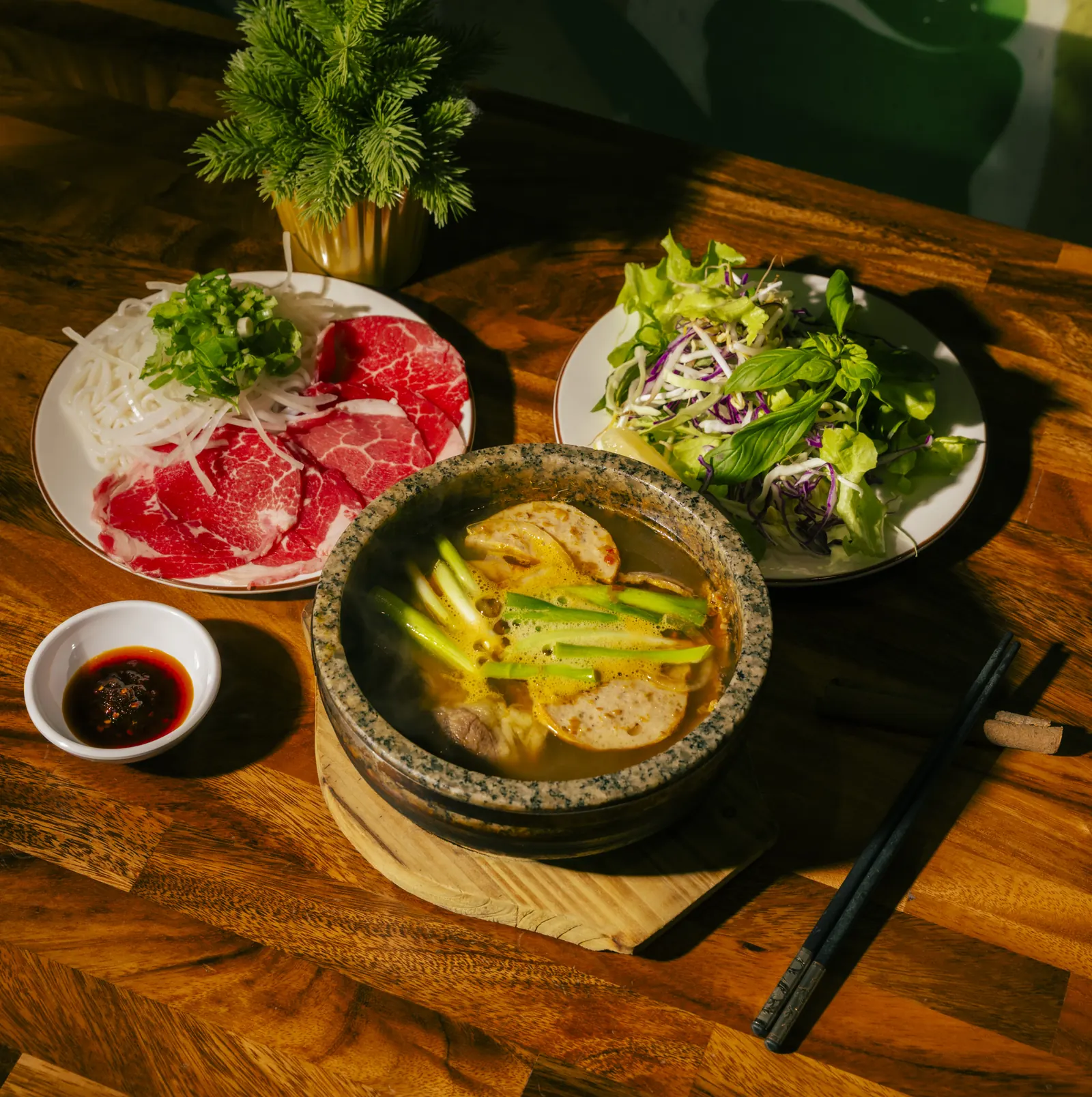 Bún bò huế, cơm tấm and shared plates on the table at Bà Năm Restaurant, Grote Street Adelaide