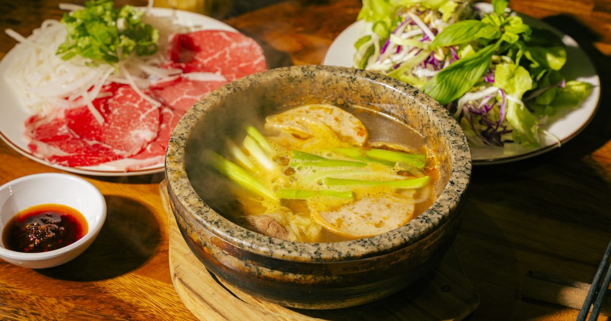 Bún Bò Huế Thố Đá — spicy lemongrass beef and pork noodle soup steaming in a stone bowl at Bà Năm Restaurant, Adelaide