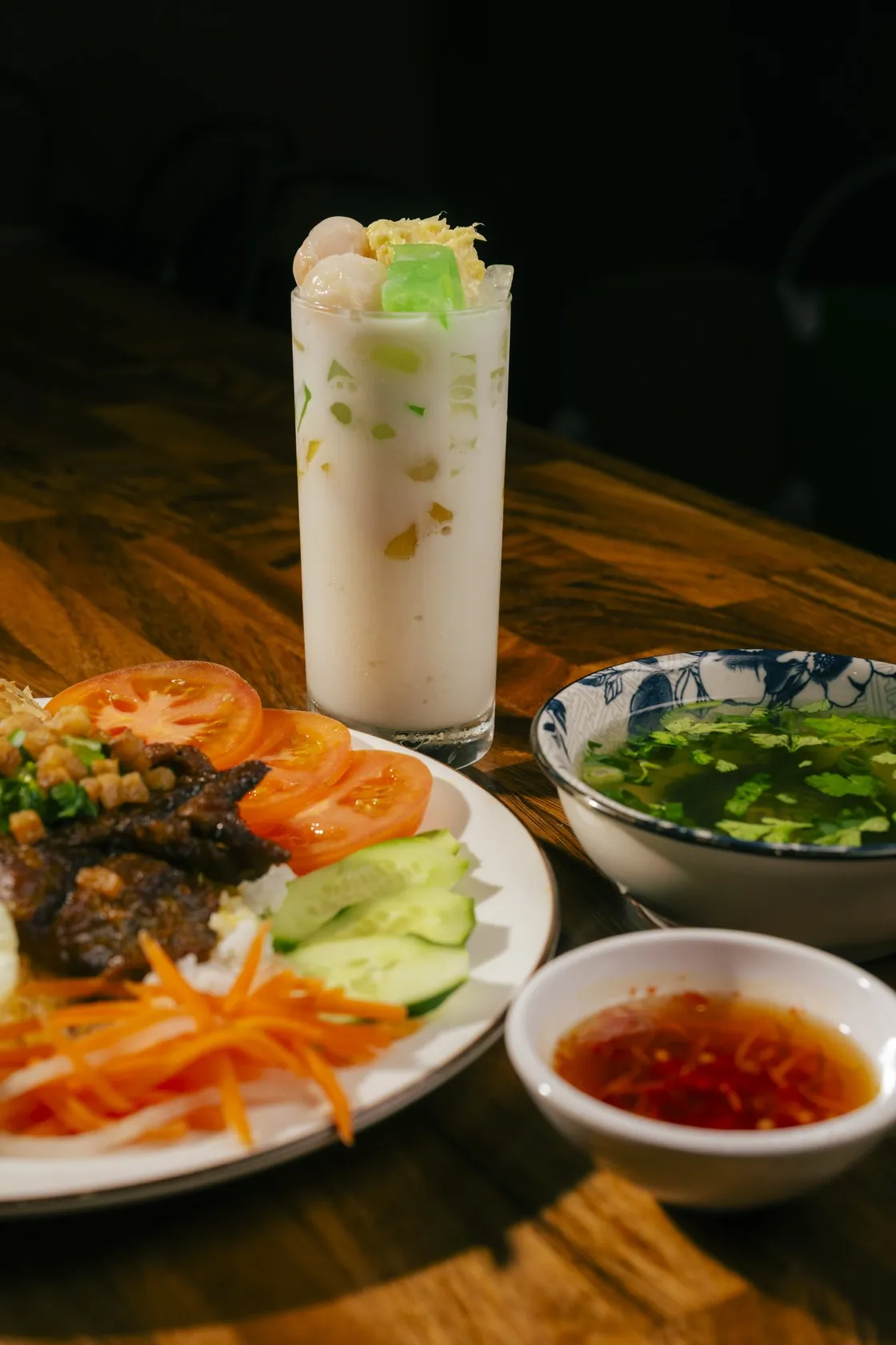 Cơm tấm at Bà Năm, Adelaide — broken rice with grilled meat, tomato, cucumber, pickles, soup and a tall coconut milk drink
