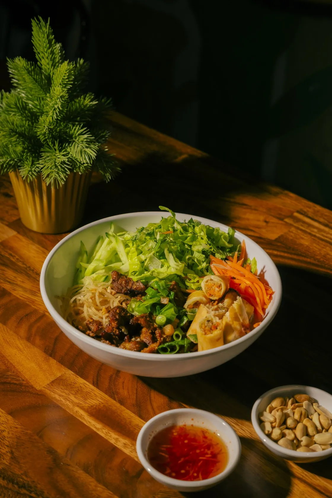 Phở Thố Đá at Bà Năm, 65 Grote Street Adelaide — granite stone bowl with fish cake, rare beef, spring onion and herbs, plus a side plate of paper-thin red-coin rare beef with onion, herbs and bean sprouts, and a fresh herb salad with lemon