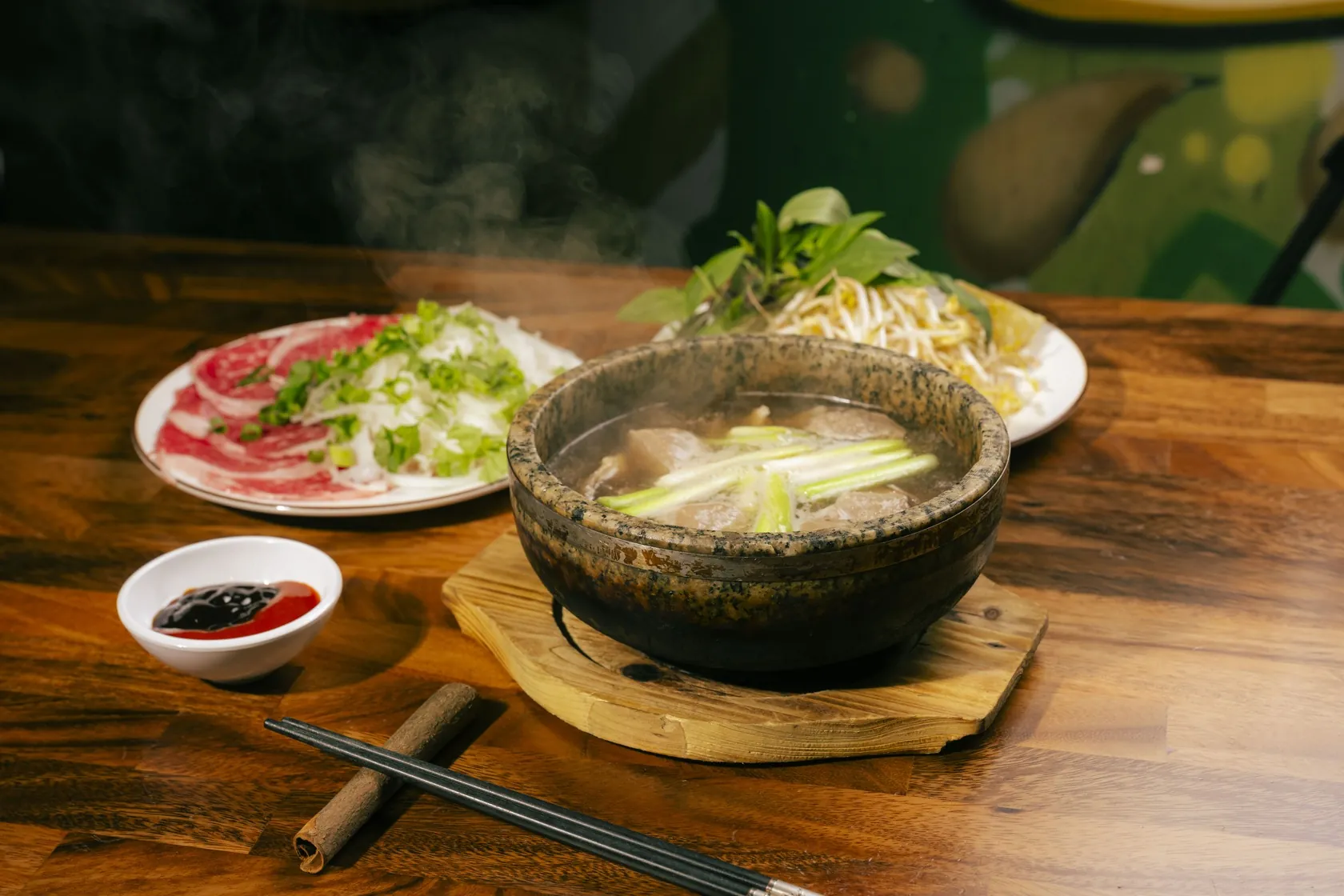Steaming stone-bowl phở with red-coin rare beef plate at Bà Năm — near Waymouth Street Adelaide