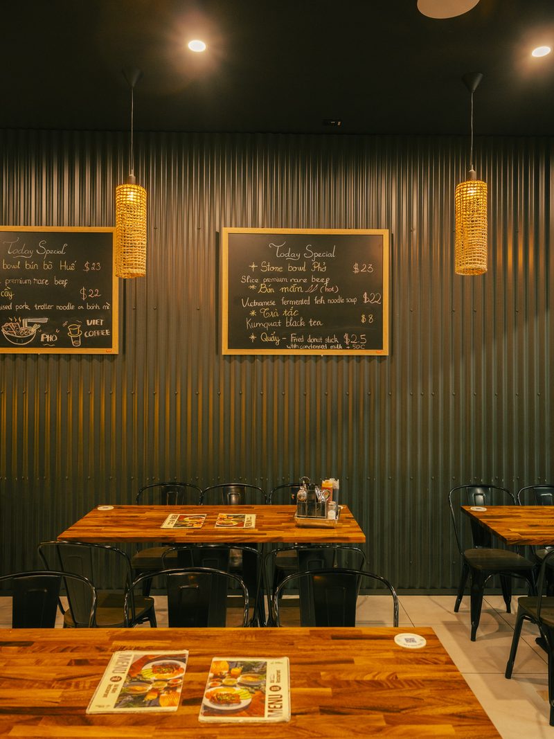 Bà Năm dining room — warm lighting, wooden tables, Vietnamese decor