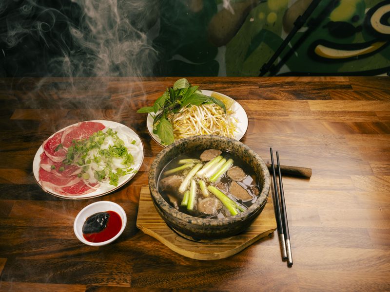 Bún Bò Huế Thố Đá — steaming stone bowl of spicy beef noodle soup
