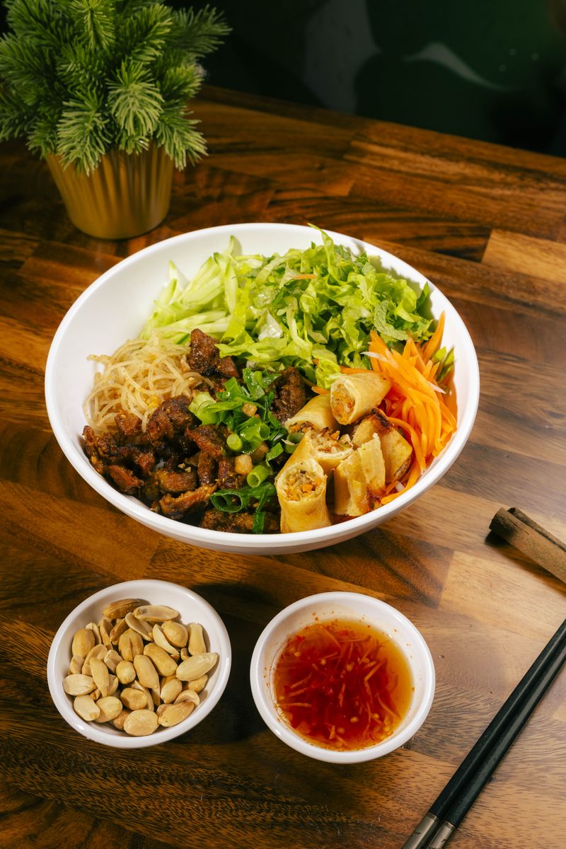 Bún Thịt Nướng Đặc Biệt — grilled pork and chả giò vermicelli bowl with peanuts and nước chấm