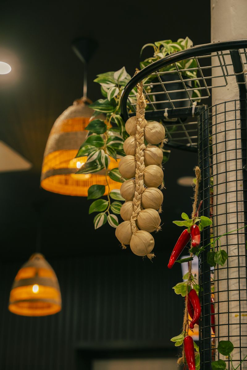 Woven rattan pendant lights and hanging garlic inside Bà Năm